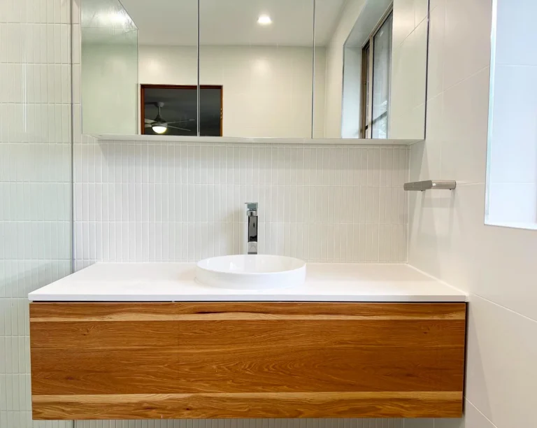 Timber vanity, white basin and mirrored cabinetry in an RJG Lugarno bathroom