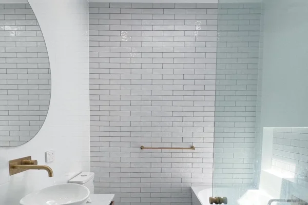 image of a bathroom with grab bars, vanity and bathtub