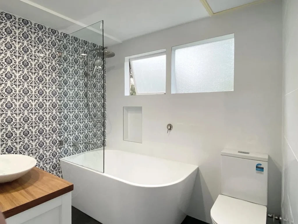 image of a bathroom with toilet, bathtub, shower and bathroom vanity