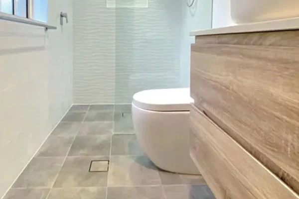 image of a bathroom with toilet and shower, after renovation in oakhurst