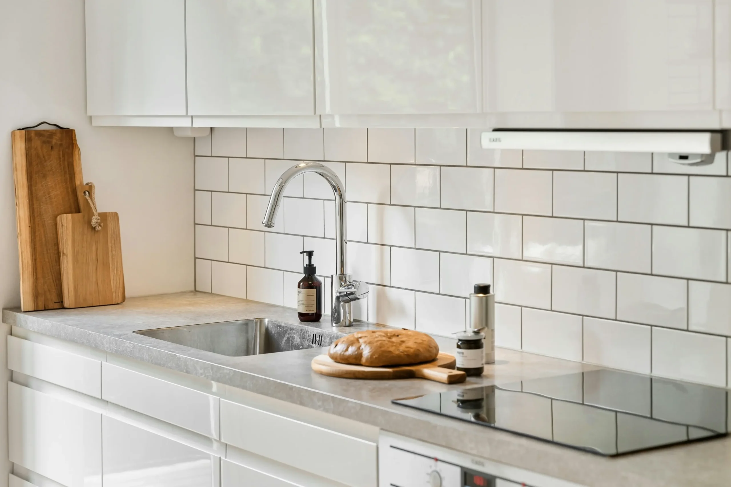 kitchen with faucet and bread for topic on choosing the right backsplash design